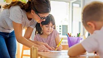 Teacher working with two children.